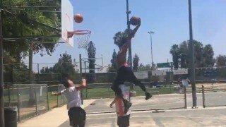 Suns' Derrick Jones Jr. Jumps Over Unsuspecting Civilian During #DriveByDunkChallenge