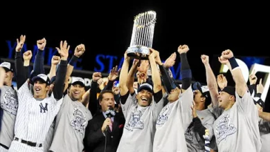 New York Yankees celebrate their American League title with the trophy held aloft