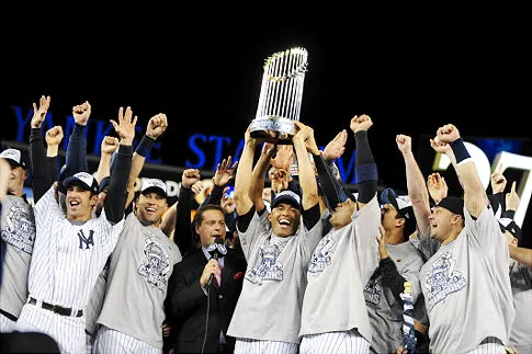 New York Yankees celebrate their American League title with the trophy held aloft