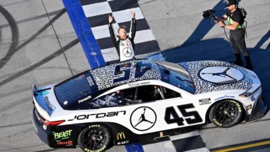 Tyler Reddick celebrating next to his car NASCAR Playoffs