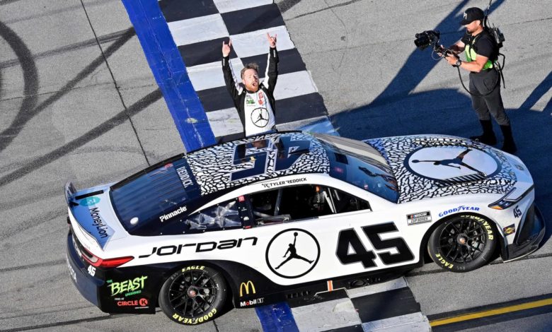 Tyler Reddick celebrating next to his car NASCAR Playoffs