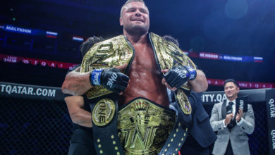 Anatoly Malylhin holding three belts